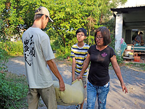賴裕仁幫忙父母搬米，要送去碾米廠碾米了